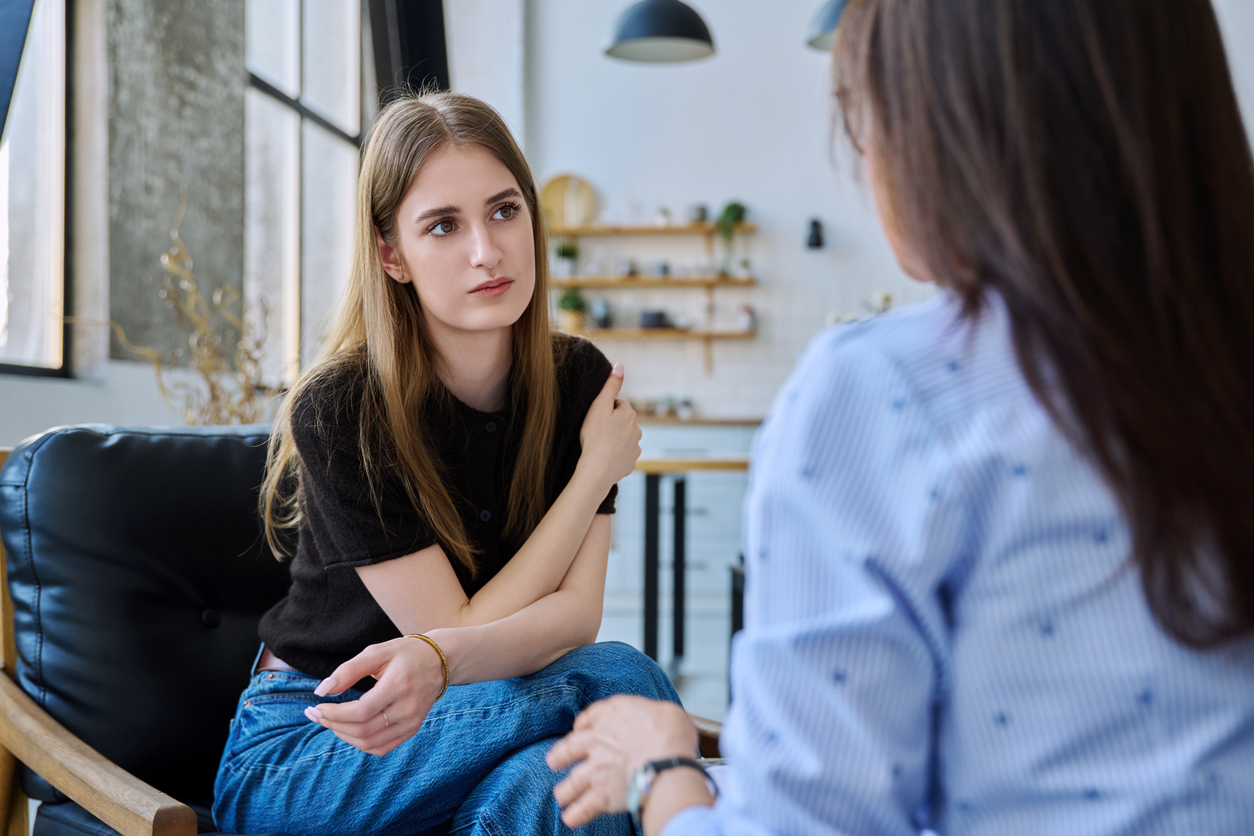Young woman talking to social worker