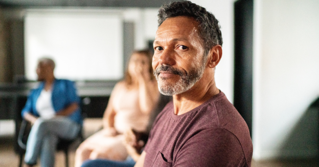 Image of older man in group therapy