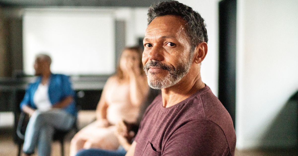 Image of older man in group therapy