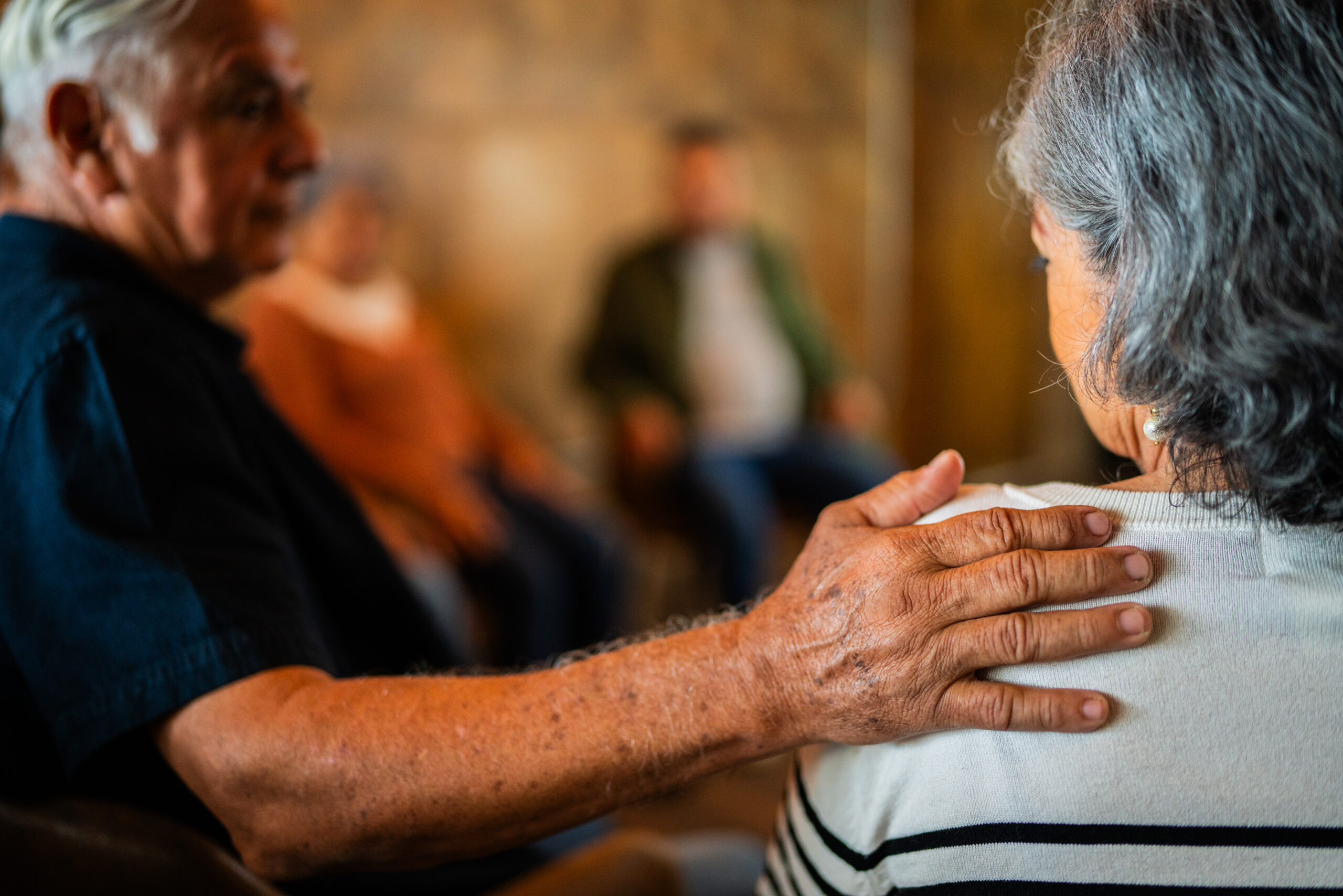 Close-up of a people giving support to patient during group therapy session